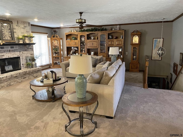 living room featuring carpet floors, a fireplace, ornamental molding, ceiling fan, and a textured ceiling