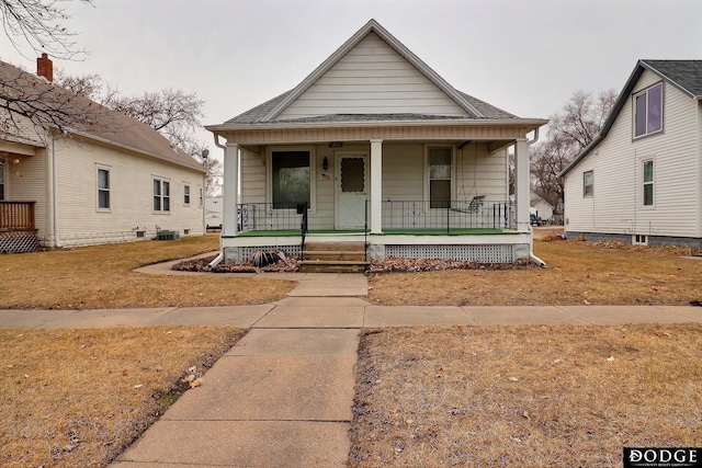 bungalow-style home featuring covered porch and a shingled roof