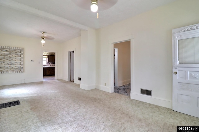 unfurnished living room featuring carpet, beam ceiling, visible vents, and a ceiling fan