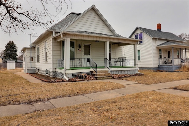 view of front of house with a porch and roof with shingles