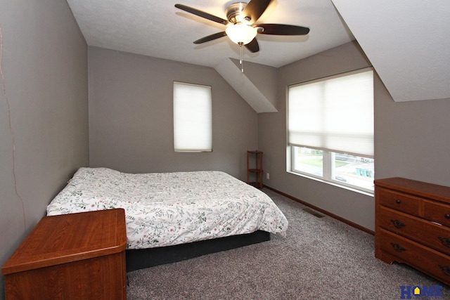 bedroom with carpet floors, baseboards, visible vents, and lofted ceiling