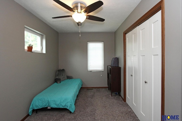 carpeted bedroom featuring ceiling fan, baseboards, and a closet