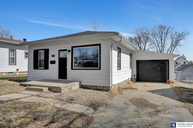 view of front of home with concrete driveway and an attached garage