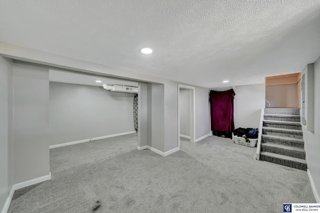 finished below grade area featuring recessed lighting, stairway, carpet flooring, a textured ceiling, and baseboards