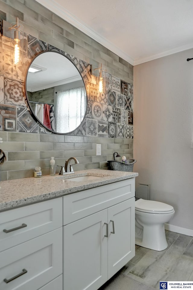 full bath with toilet, tasteful backsplash, crown molding, and vanity