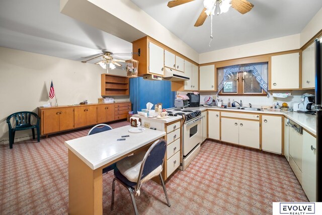 kitchen featuring white appliances, light countertops, ceiling fan, and a sink