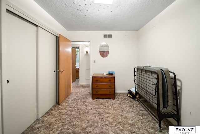 office area featuring visible vents, a textured ceiling, and carpet floors