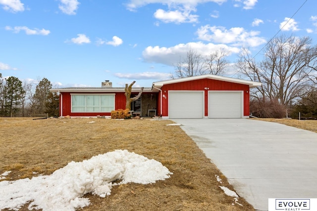 single story home featuring a chimney, concrete driveway, a garage, and a front yard