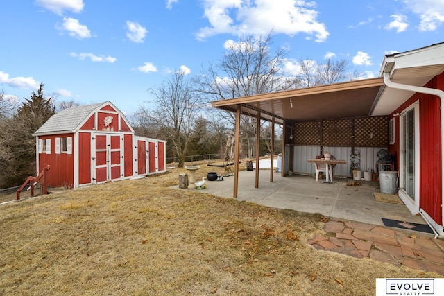 view of yard with a patio, an outbuilding, a storage shed, and fence