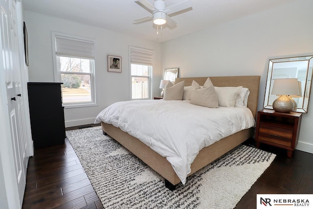 bedroom featuring ceiling fan, baseboards, and dark wood-type flooring