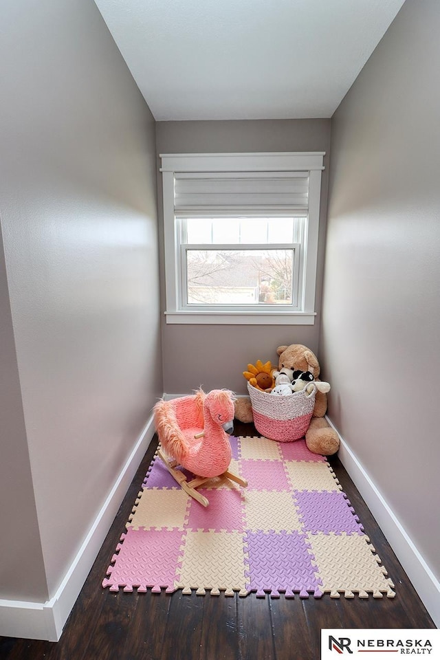 bedroom featuring baseboards and wood finished floors