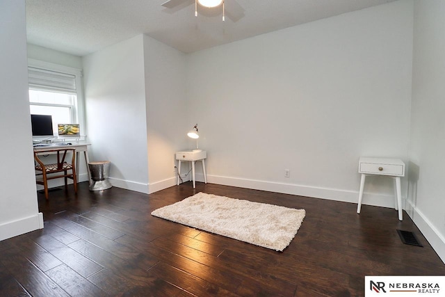 interior space with visible vents, baseboards, and wood finished floors