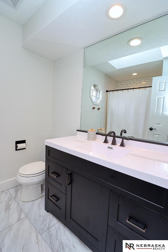 bathroom featuring toilet, recessed lighting, vanity, baseboards, and marble finish floor