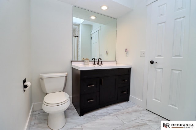 bathroom with toilet, marble finish floor, baseboards, and vanity