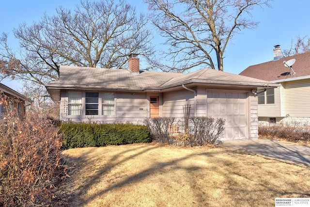 exterior space with concrete driveway, a chimney, and an attached garage