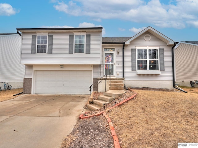 tri-level home with a garage and driveway