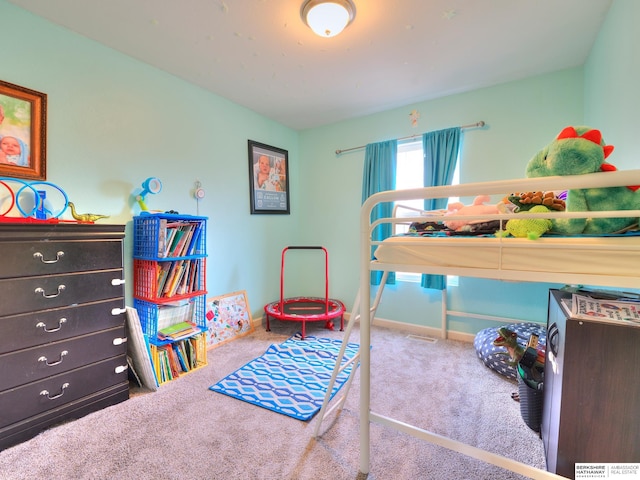 bedroom with carpet floors and baseboards