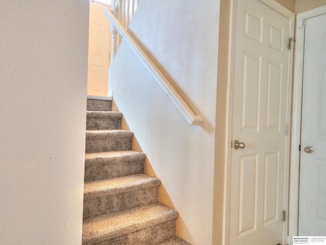 stairs featuring a textured wall