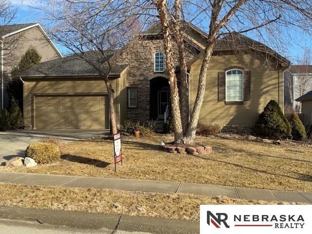 view of front of property with a garage and concrete driveway