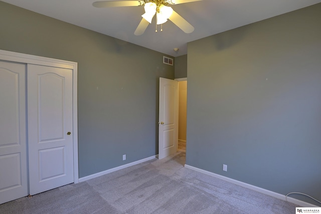 unfurnished bedroom featuring ceiling fan, carpet floors, visible vents, baseboards, and a closet