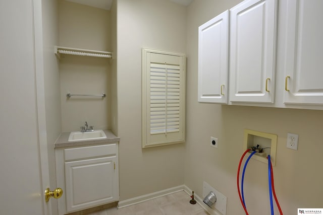 laundry area featuring washer hookup, cabinet space, a sink, electric dryer hookup, and baseboards