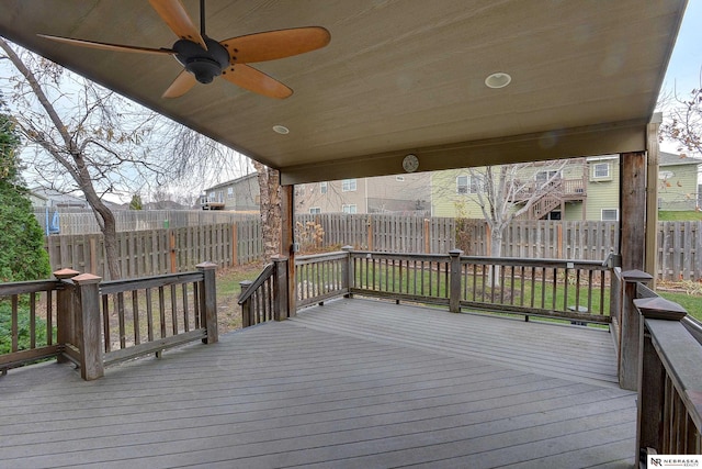 deck with a fenced backyard and a ceiling fan