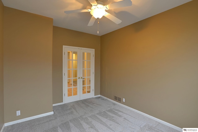 spare room with carpet, french doors, visible vents, ceiling fan, and baseboards