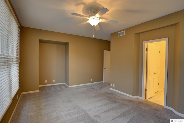 unfurnished bedroom with baseboards, visible vents, and light colored carpet