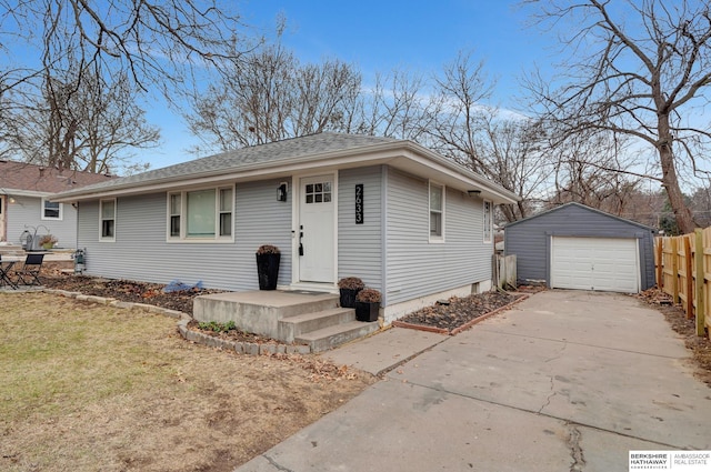 view of front of house with an outbuilding, roof with shingles, fence, a garage, and driveway