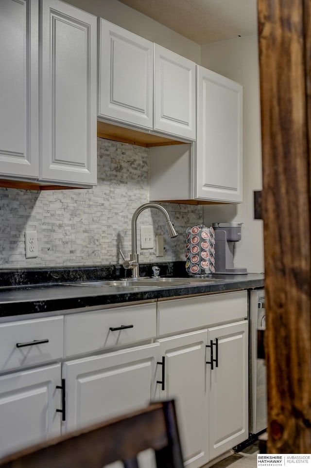 kitchen with tasteful backsplash and white cabinets