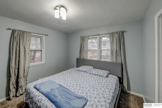 carpeted bedroom featuring baseboards