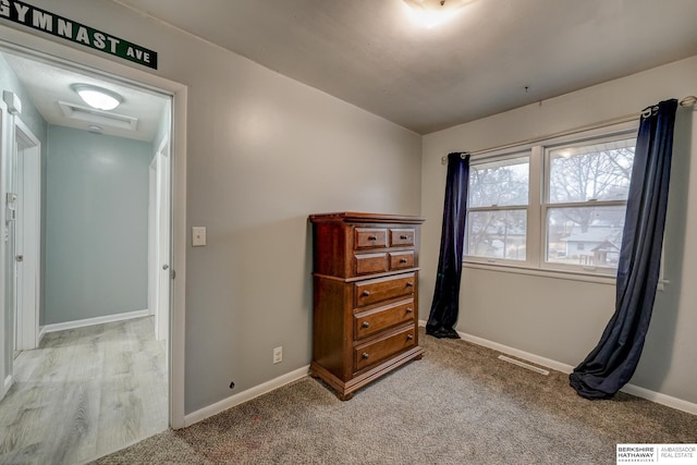 unfurnished bedroom featuring baseboards, visible vents, and carpet flooring