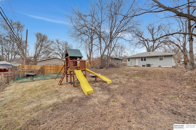 exterior space featuring fence and a playground