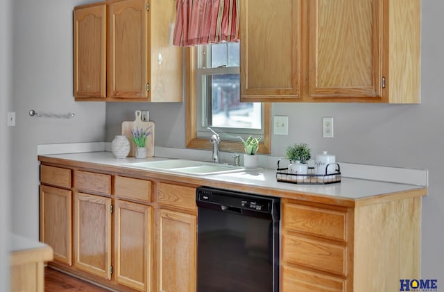 kitchen featuring a sink, light brown cabinets, light countertops, and dishwasher