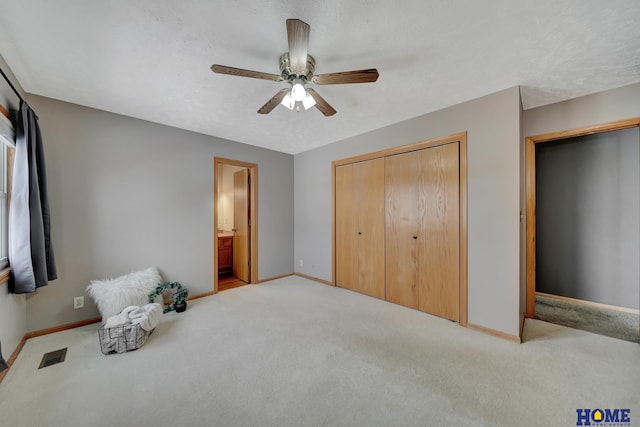 living area with baseboards, visible vents, ceiling fan, a textured ceiling, and carpet floors