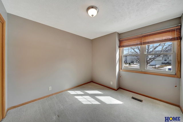 unfurnished room with carpet, baseboards, and visible vents