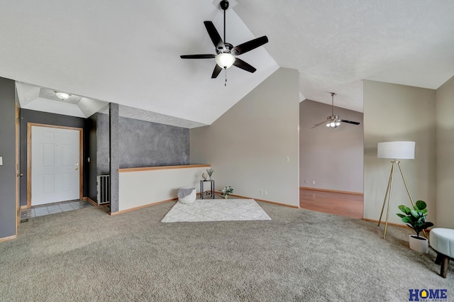 unfurnished living room featuring baseboards, visible vents, a ceiling fan, lofted ceiling, and carpet floors