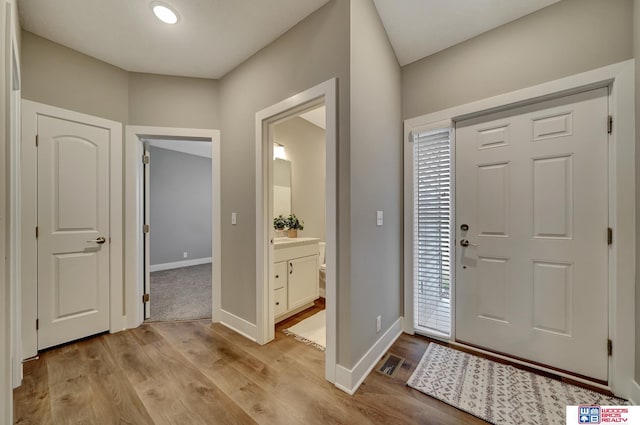 entrance foyer featuring light wood-type flooring, visible vents, and baseboards