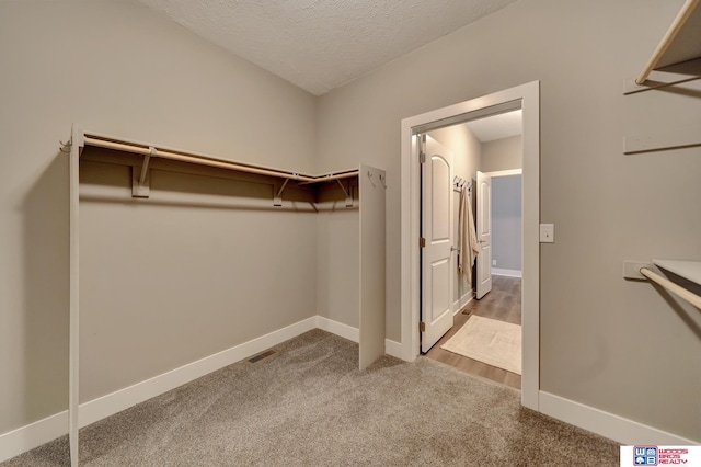 spacious closet with carpet floors and visible vents