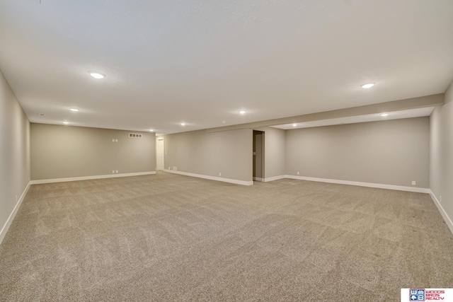 finished basement with recessed lighting, light colored carpet, and baseboards