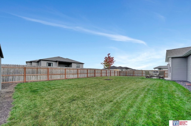 view of yard with a fenced backyard