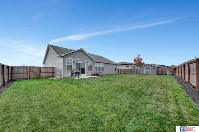 back of property featuring a fenced backyard, a lawn, an outdoor structure, and a storage shed