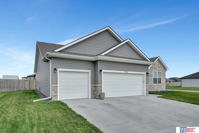 view of front facade featuring an attached garage, fence, concrete driveway, stone siding, and a front lawn