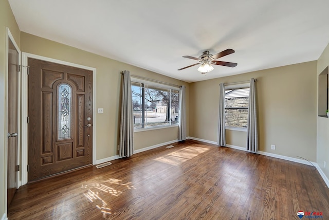 entrance foyer featuring a ceiling fan, visible vents, wood finished floors, and baseboards