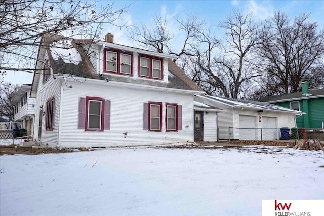 view of front of house with a garage and a chimney