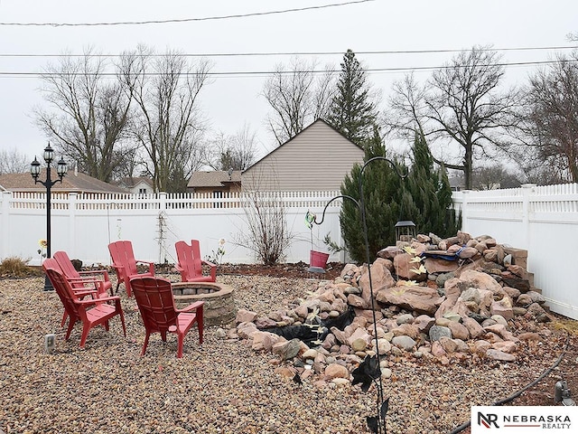 view of yard featuring an outdoor fire pit and a fenced backyard