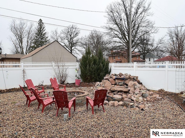 view of yard featuring an outdoor fire pit and a fenced backyard