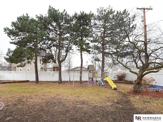 view of yard with a playground and a fenced backyard