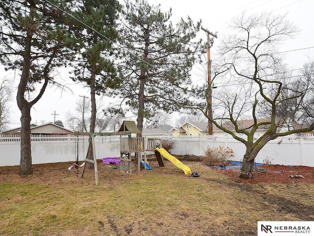 view of yard featuring a fenced backyard and a playground