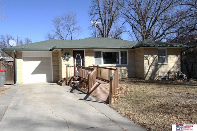 single story home featuring a garage, driveway, and a shingled roof